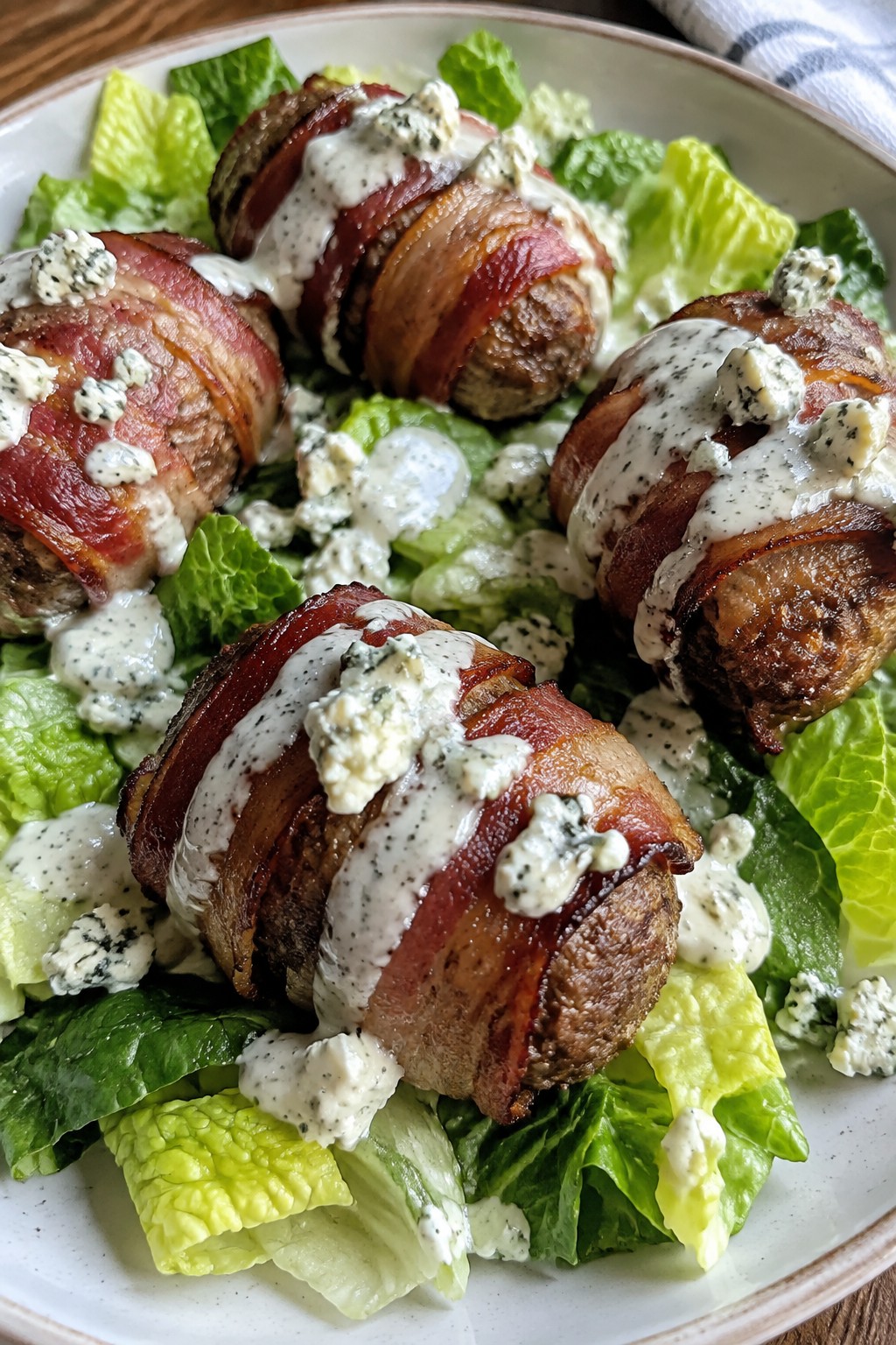 Buffalo Bacon-Wrapped Mini Meatloaves on a Crispy Romaine Salad with Blue Cheese Dressing