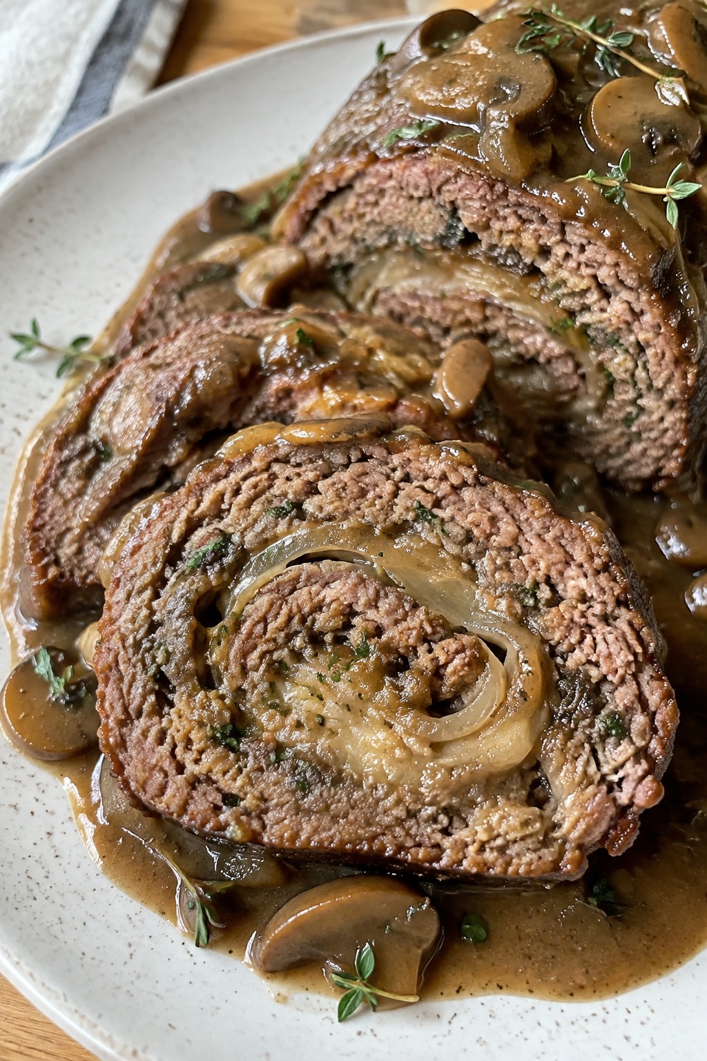 Herbed French Onion Meatloaf Roll with Mushroom Onion Gravy